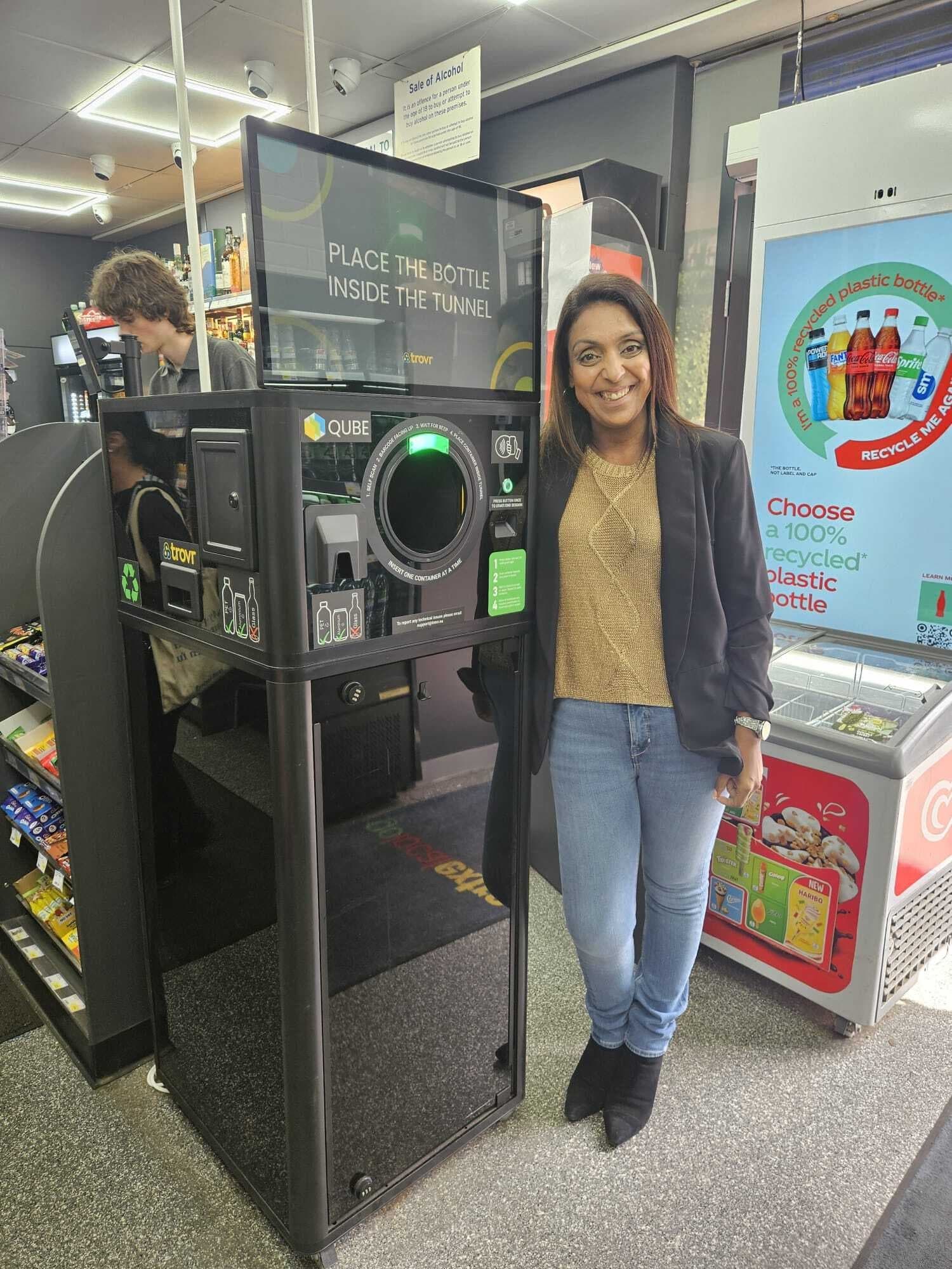 Nathalie Fullerton standing beside a TrovrQUBE installed in her Go Local store in Glasgow.
